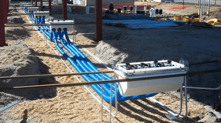 Blue piping being laid underground